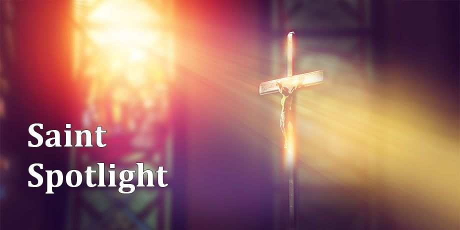 A Crucifix in church with ray of light shining on it from a stained glass window