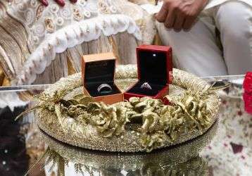 Rings sit on a table in preparations for the Pakistani couple's wedding.