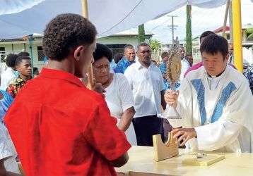Columban Fr. Carlo Jung Euikyun with parishioners during the Corpus Christi Sunday procession