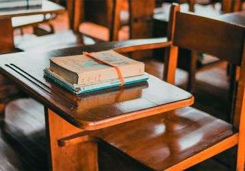 School desks with books on them