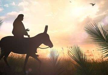 Jesus riding a donkey surrounded by palms
