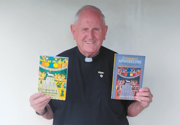 Fr. Donal McIlwraith holding books